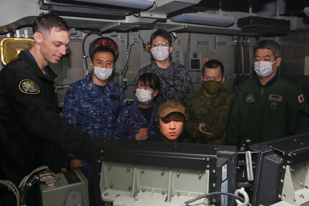 Abraham Lincoln Sailors and JMSDF military leaders observe a sonar module