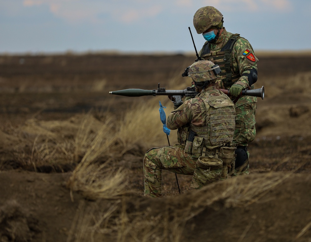 U.S. Army Soldiers work with Romanian forces during a Combined Arms Live Fire Exercise.