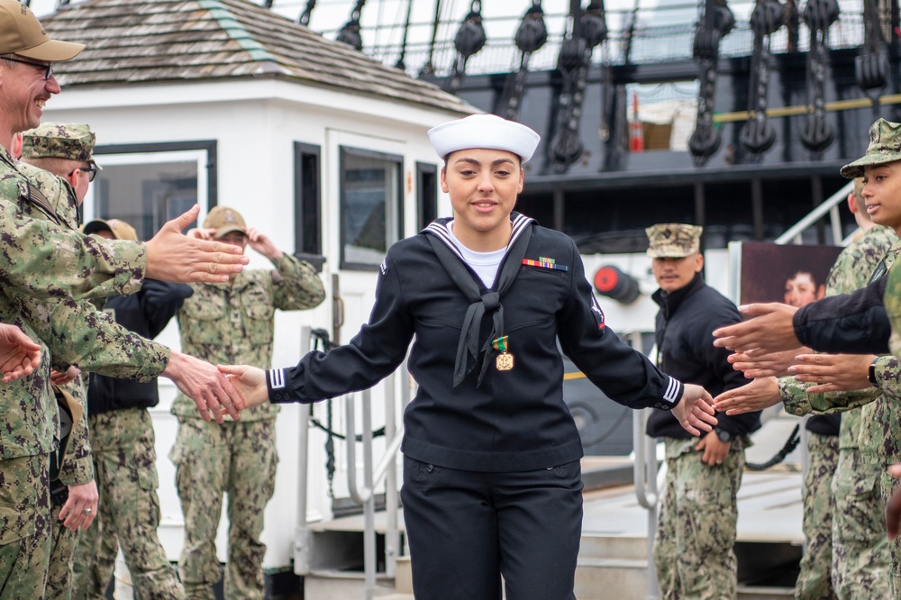Gunner's Mate 3rd Class Sarah Frank bids farewell to the officers and crew of Constitution after completing her tour aboard