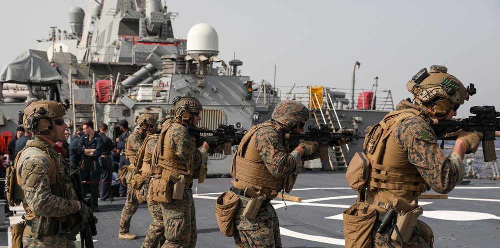 Marines aboard USS Ross hold small arms shoot