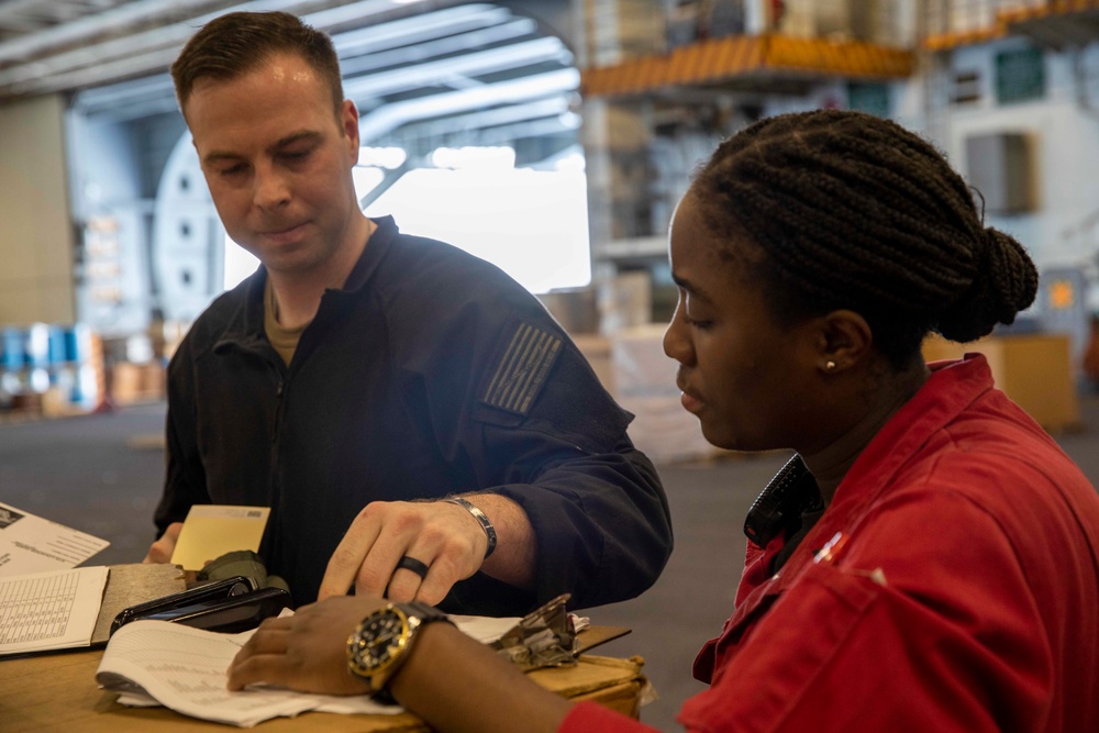 GHWB Sailor Distributes Gas Mask