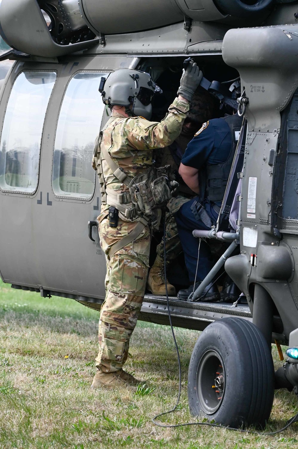 A 12th Aviation Battalion crew chief performs safety checks prior to take off during the JBM-HH functional scale exercise April 13.