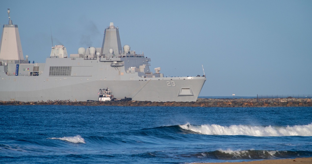 USS Anchorage (LDP 23) enters the mouth of the port at Naval Surface Warfare Center Port Hueneme Division with the help of a tugboat