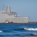USS Anchorage (LDP 23) enters the mouth of the port at Naval Surface Warfare Center Port Hueneme Division with the help of a tugboat