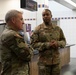 U.S. Army Europe and Africa’s Command Sgt. Maj. Jeremiah E. Inman converses with Command Sgt. Maj. James R. Holmes III, the 35th commandant of the 7th Army Noncommissioned Officer Academy