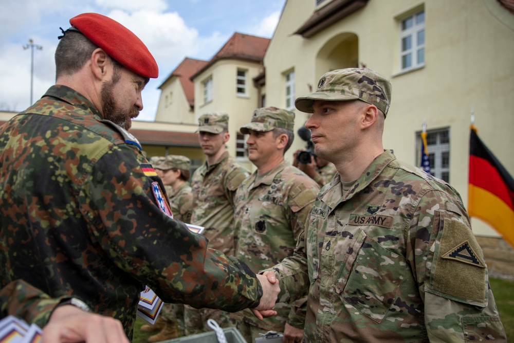U.S. Army Staff Sgt. Sani Maloku shakes hands with German Oberstleutnant (Ltc.) Florian Rommel