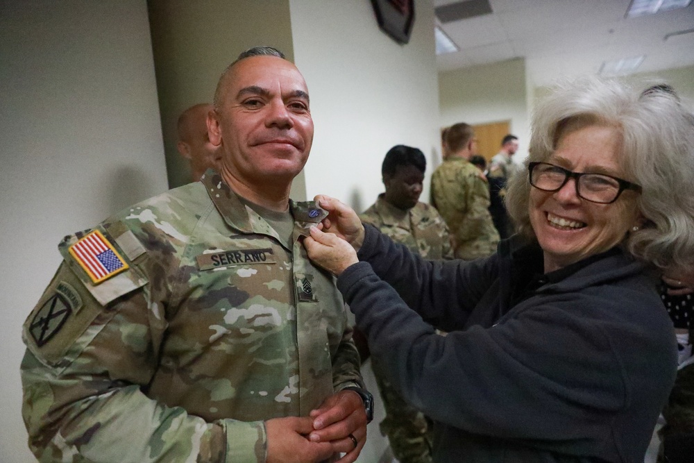 Command Sgt. Major Serrano is presented a 360 Leaders' Course pin during Graduation