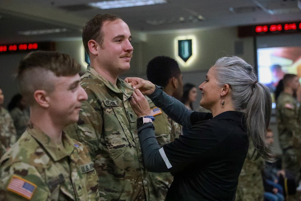 Leader presents the Fort Riley Graduation class with pins