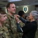 Leader presents the Fort Riley Graduation class with pins