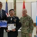 Brigadier General Stanco presents SGT Andres Saenz with a 360 Leaders course certificate