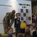 Chaplain Key from the First Infantry Division talks with students about education and childhood goals at Oliver Brown Elementary School in Manhattan, Kansas.