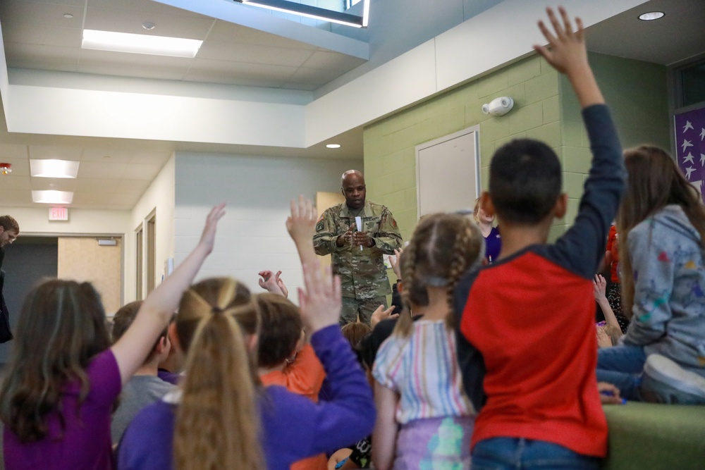 Chaplain Key from the First Infantry Division talks with students about education and childhood goals at Oliver Brown Elementary School in Manhattan, Kansas.