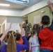 Chaplain Key from the First Infantry Division talks with students about education and childhood goals at Oliver Brown Elementary School in Manhattan, Kansas.