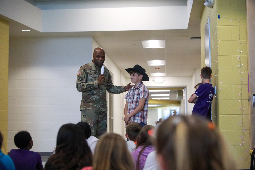 Chaplain Key from the First Infantry Division talks with students about education and childhood goals at Oliver Brown Elementary School in Manhattan, Kansas.