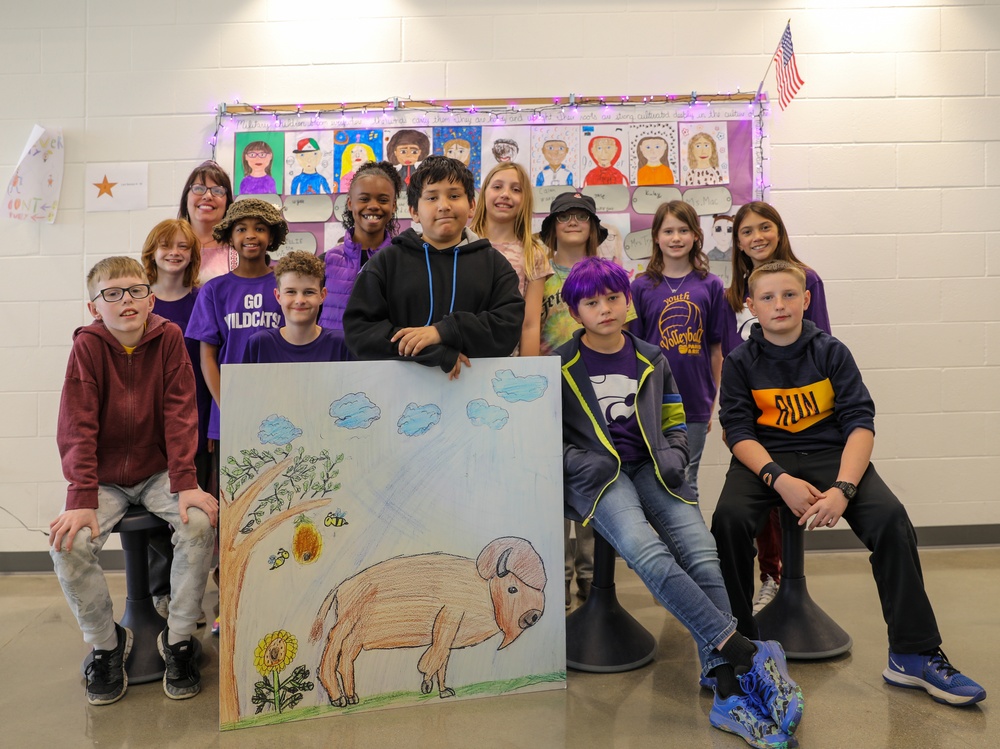 Chaplain Key from the First Infantry Division talks with students about education and childhood goals at Oliver Brown Elementary School in Manhattan, Kansas.