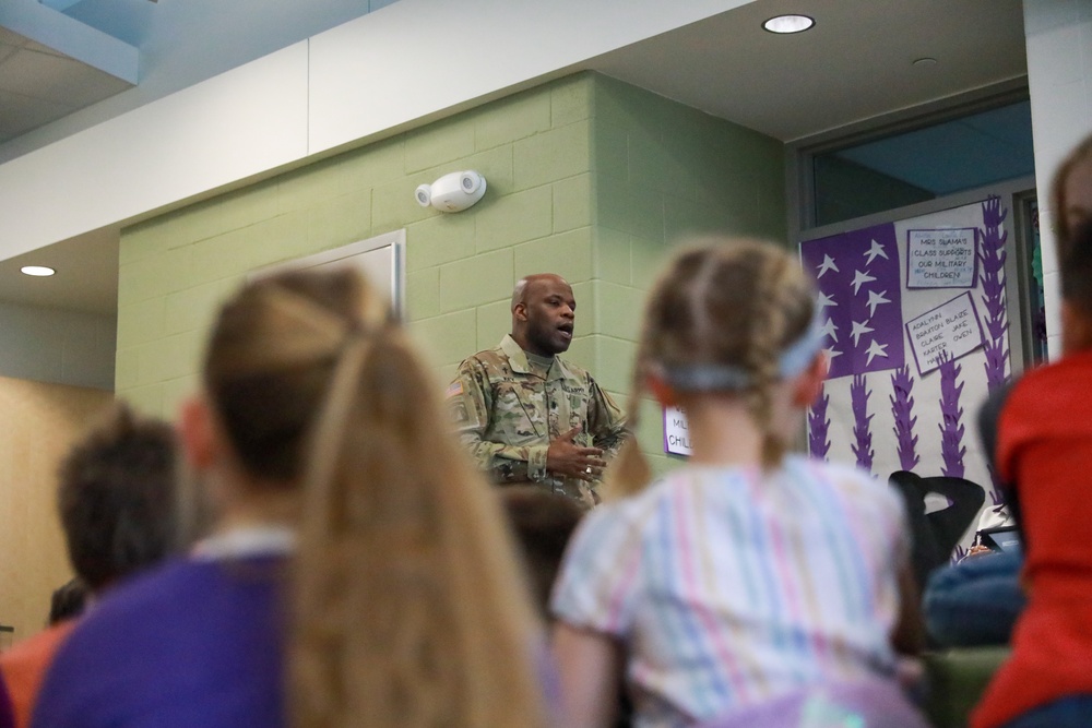 Chaplain Key from the First Infantry Division talks with students about education and childhood goals at Oliver Brown Elementary School in Manhattan, Kansas.
