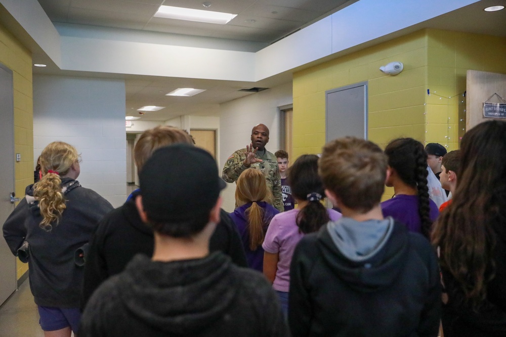 Chaplain Key from the First Infantry Division talks with students about education and childhood goals at Oliver Brown Elementary School in Manhattan, Kansas.