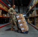 Air Force Mortuary Affairs Operations departures specialist assists with receiving logistical supplies