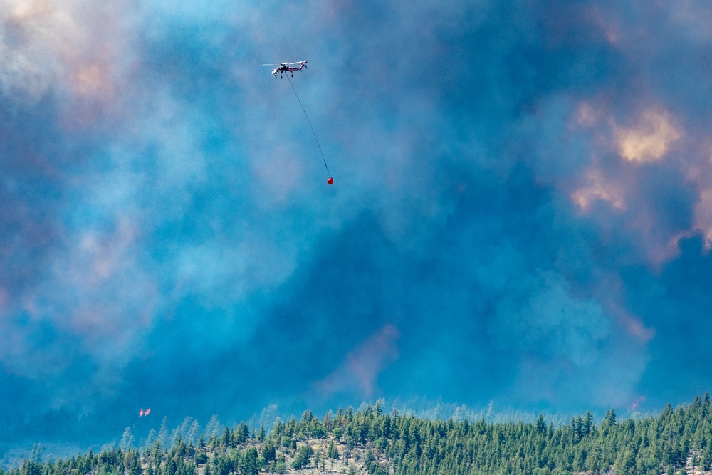 Helicopter drops water on the Beckwourth Complex Fire July 8, 2021 near Frenchman Lake in N. California