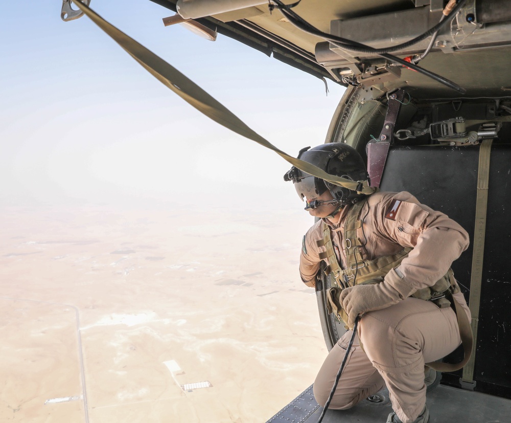 A Royal Jordanian Armed Forces Crew Chief Looks Over the Drop Zone