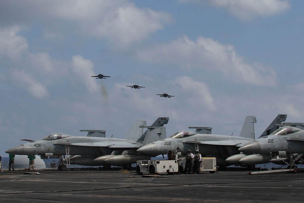 Abraham Lincoln holds an in-flight change of command ceremony for VFA-14
