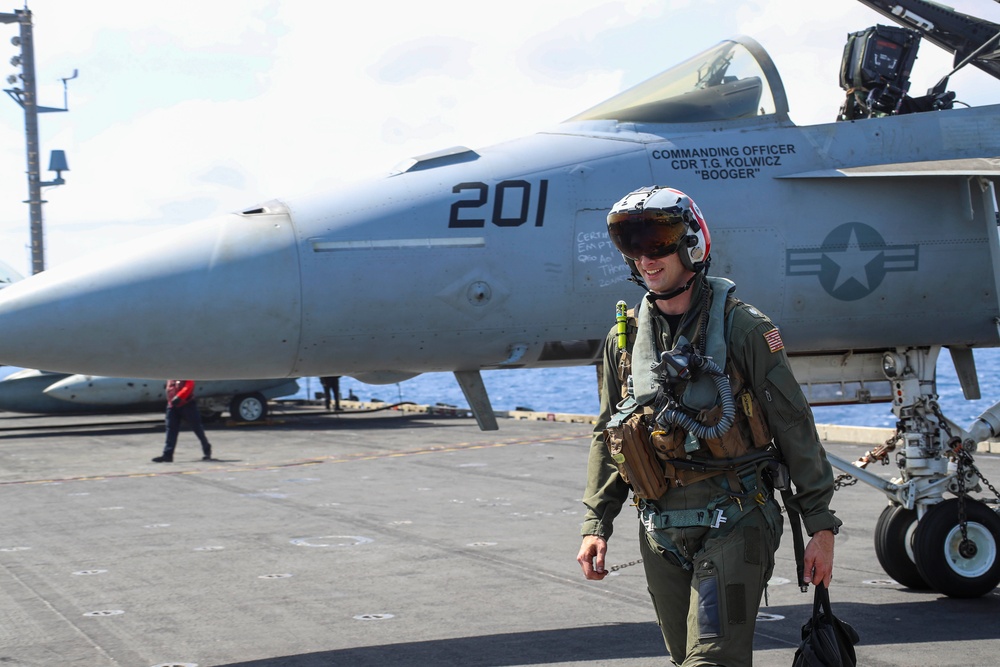 Abraham Lincoln holds an in-flight change of command ceremony for VFA-14