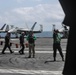 Abraham Lincoln holds an in-flight change of command ceremony for VFA-14