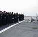 U.S. Marines onboard USS Ross present a parting gift to crew