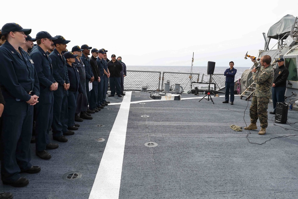 U.S. Marines onboard USS Ross present a parting gift to crew