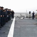 U.S. Marines onboard USS Ross present a parting gift to crew