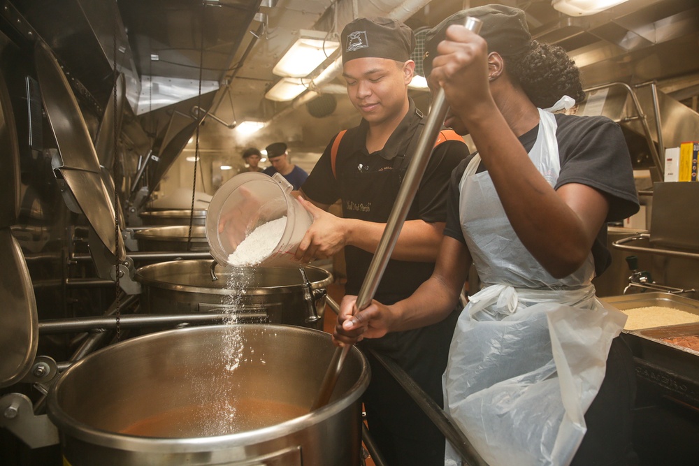 Abraham Lincoln Sailors serve food