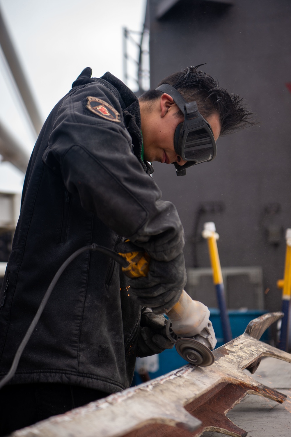 Sailor grinds paint aboard USS Carl Vinson (CVN 70)