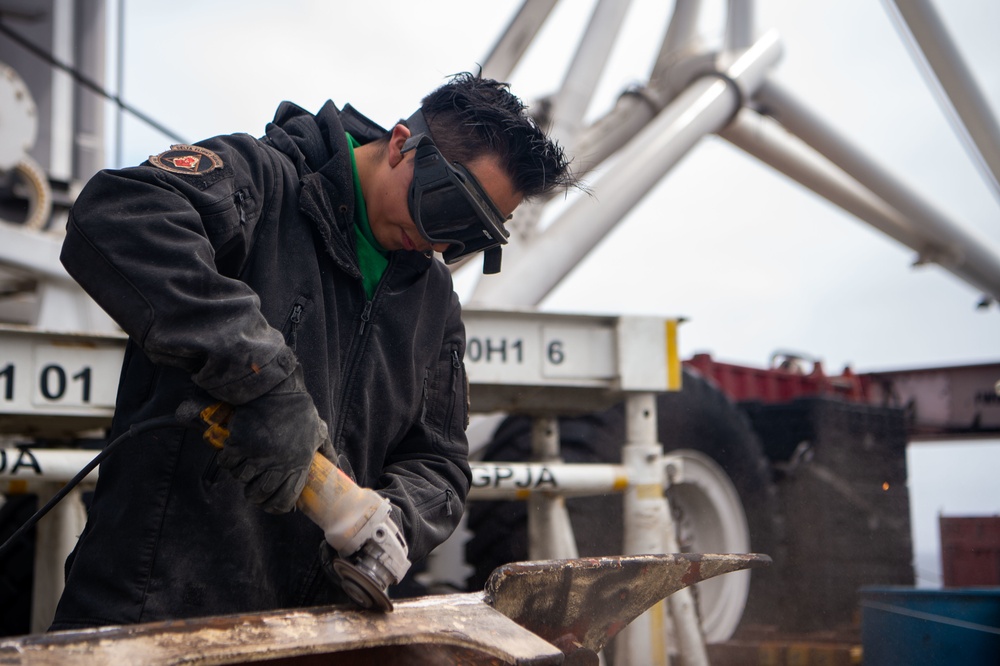 Sailor grinds paint aboard USS Carl Vinson (CVN 70)