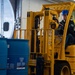 Sailors Move Supplies In The Hangar Bay Aboard USS Carl Vinson (CVN 70)