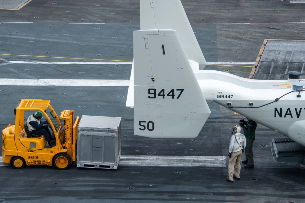 Sailors Load Supplies Into A CMV-22B Osprey, Assigned to the “Titans” of Fleet Logistics Multi-Mission Squadron (VRM) 30