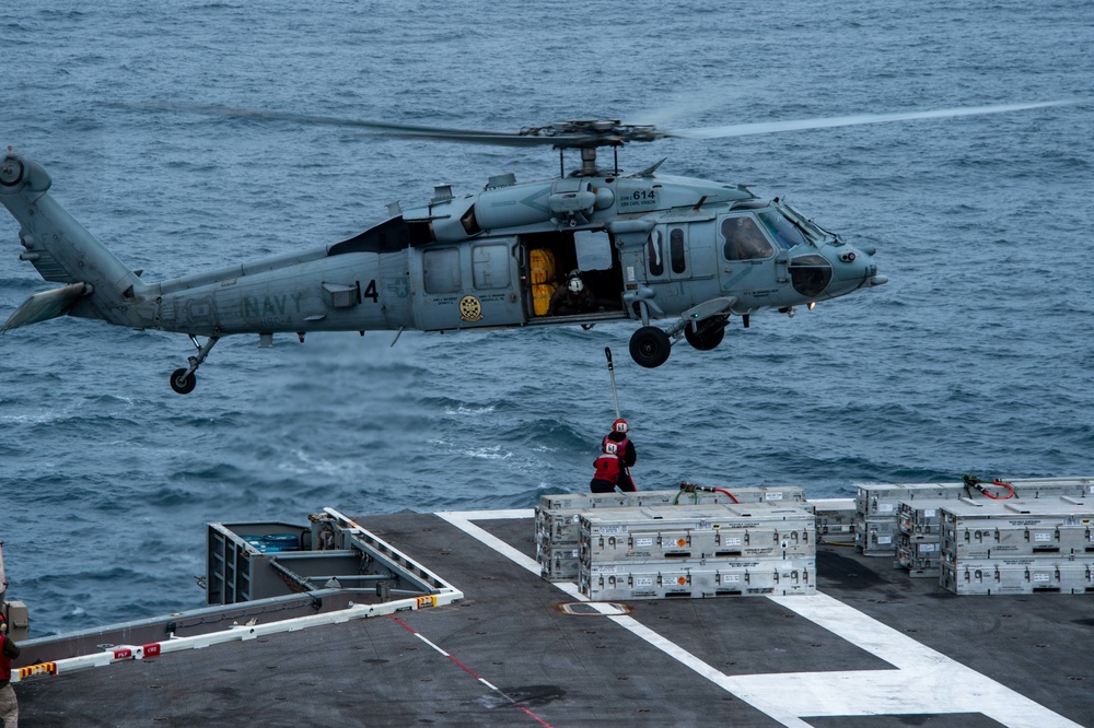 Sailors Hook Ammunition Onto  an MH-60S Sea Hawk, Assigned to the “Black Knights” of Helicopter Sea Combat Squadron (HSC) 4