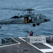 Sailors Hook Ammunition Onto  an MH-60S Sea Hawk, Assigned to the “Black Knights” of Helicopter Sea Combat Squadron (HSC) 4