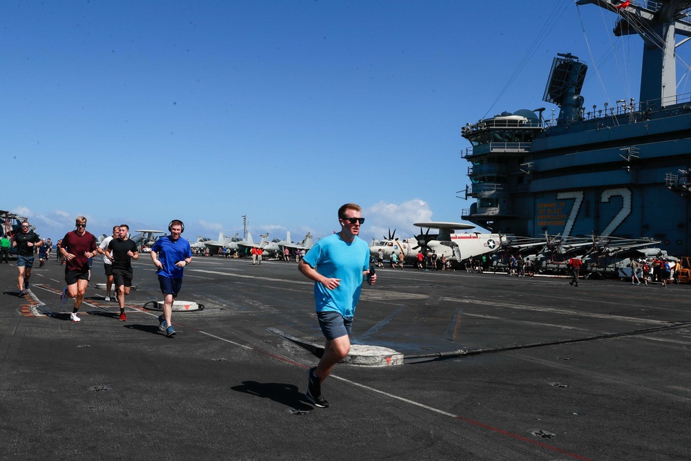 Abraham Lincoln Sailors run on the flight deck