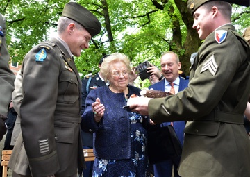 Soldiers from U.S. Army Garrison Italy return a birthday cake after 77 years