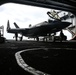 Abraham Lincoln Sailors transport aircraft in the hangar bay