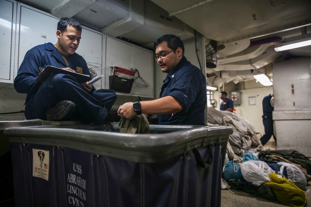 Abraham Lincoln Sailors conduct inventory