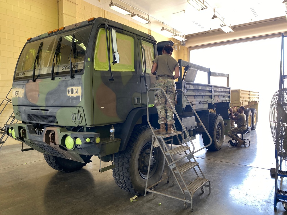 Soldiers prepping an FMTV for painting
