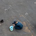 Sailors clean pad-eyes on the flight deck of Nimitz-class aircraft carrier USS Carl Vinson