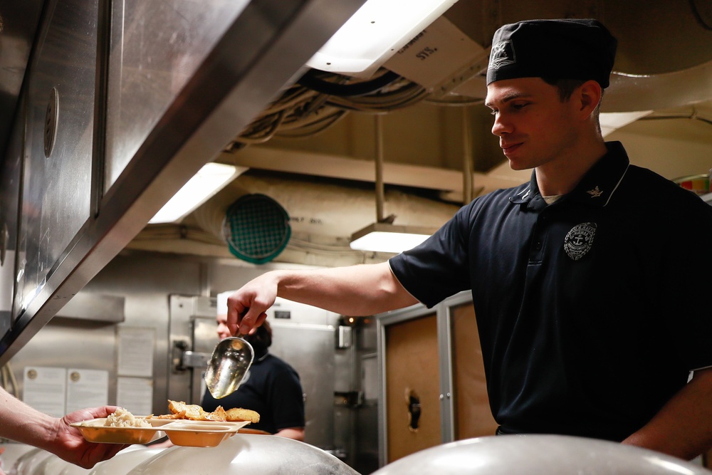 Abraham Lincoln Sailors serve food