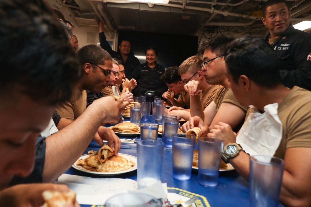 Mobile Bay Sailors compete in a pancake eating contest