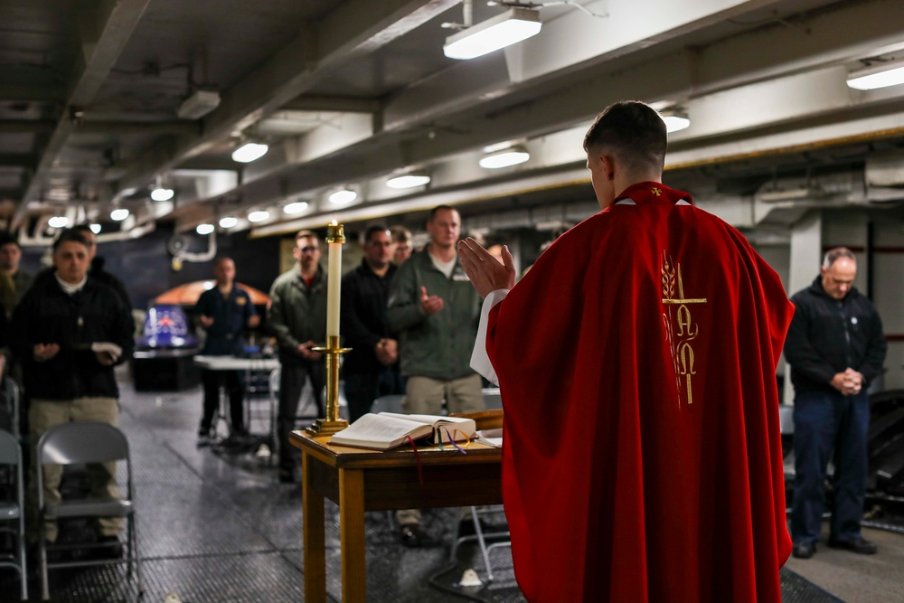 Abraham Lincoln Sailors participate in a Roman Catholic Mass service