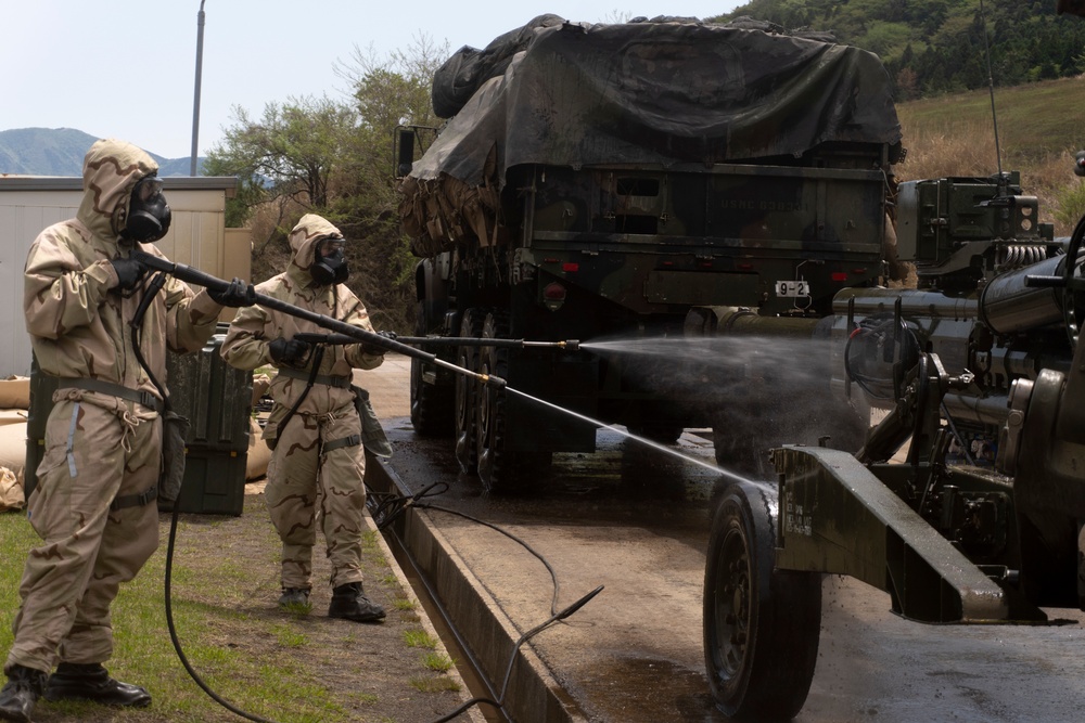 Soldiers using M26 to decontaminate vehicles