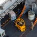 Sailors transport supplies into the hangar bay of Nimitz-class aircraft carrier USS Carl Vinson