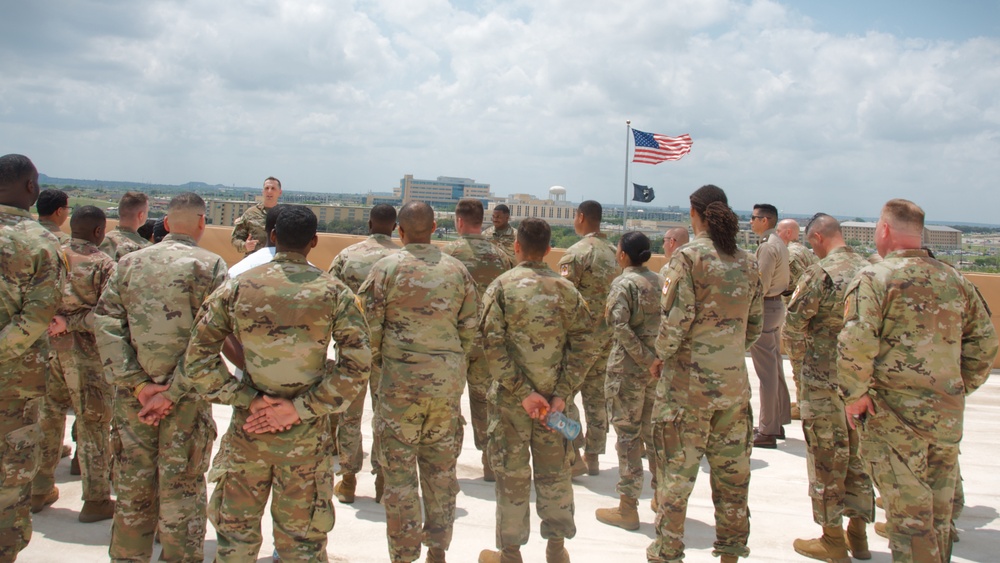 Fort Hood Soldier reenlists on top of the III Corps Headquarters