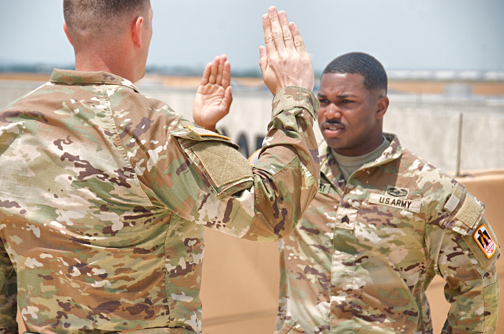 Fort Hood Soldier reenlists on top of the III Armored Corps Headquarters